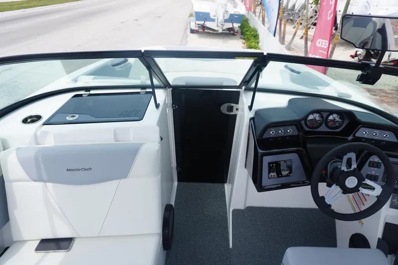Slide: The Image of 2023 MasterCraft NXT24 boat interior with modern dashboard and seating. - 21