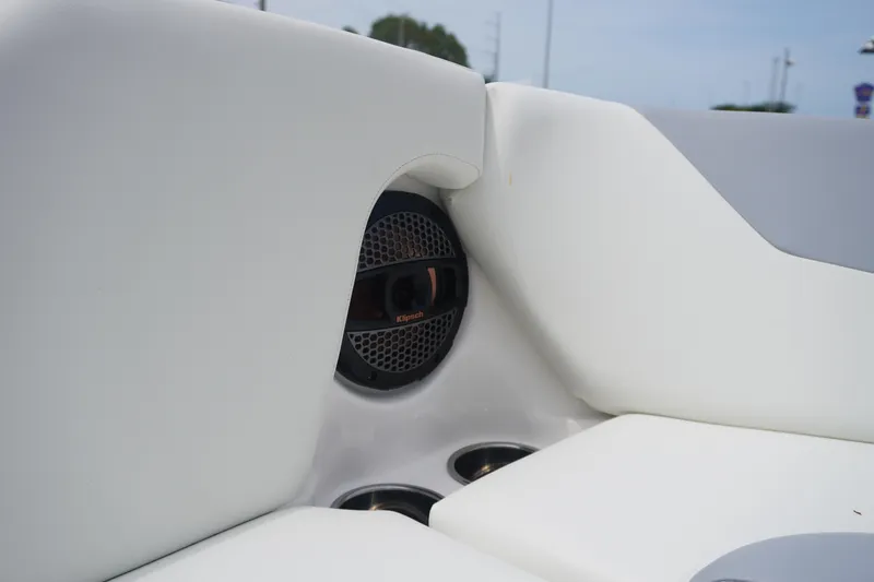 Slide: The Image of 2023 MasterCraft NXT24 boat interior with speaker and white seating. - 24