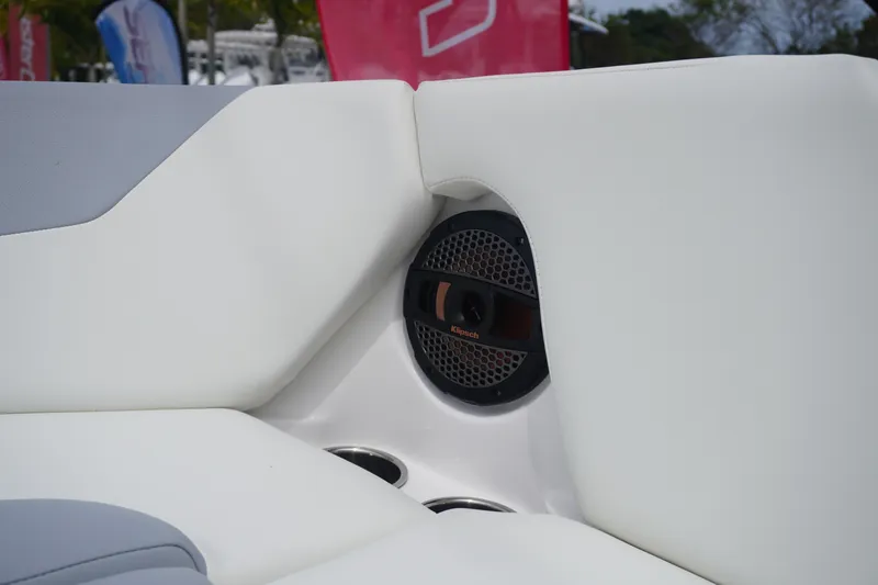 Slide: The Image of 2023 MasterCraft NXT24 boat interior with white seating and built-in speaker. - 25