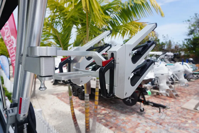 Slide: The Image of 2023 MasterCraft NXT24 boat with wakeboard rack, palm trees in background. - 3