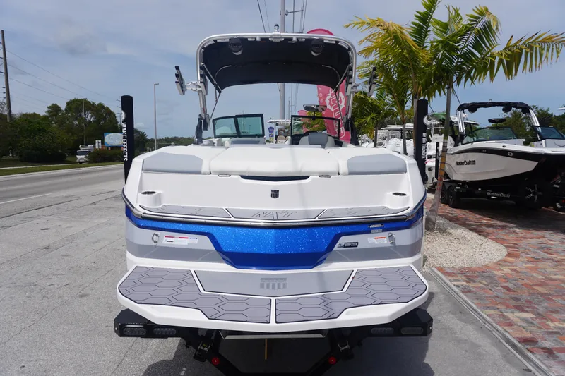 Slide: The Image of 2023 MasterCraft NXT24 boat displayed outdoors, featuring sleek design and vibrant blue accents. - 37