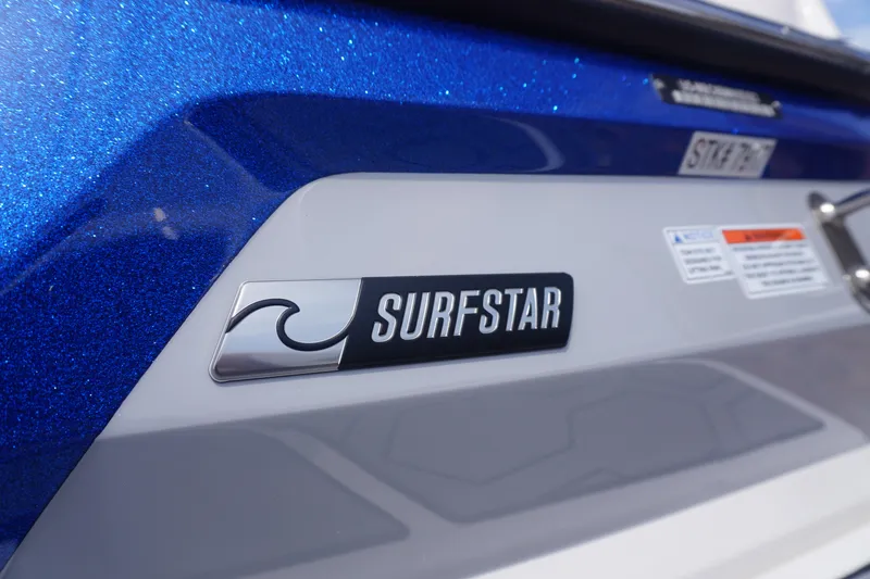 Slide: The Image of 2023 MasterCraft NXT24 boat with SurfStar logo on blue and white exterior. - 7