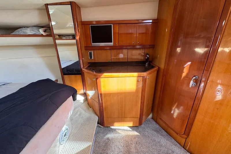 Slide: The Image of Luxurious cabin interior of 2004 Sunseeker Sportfisher 37 with wood cabinetry and compact kitchenette. - 100