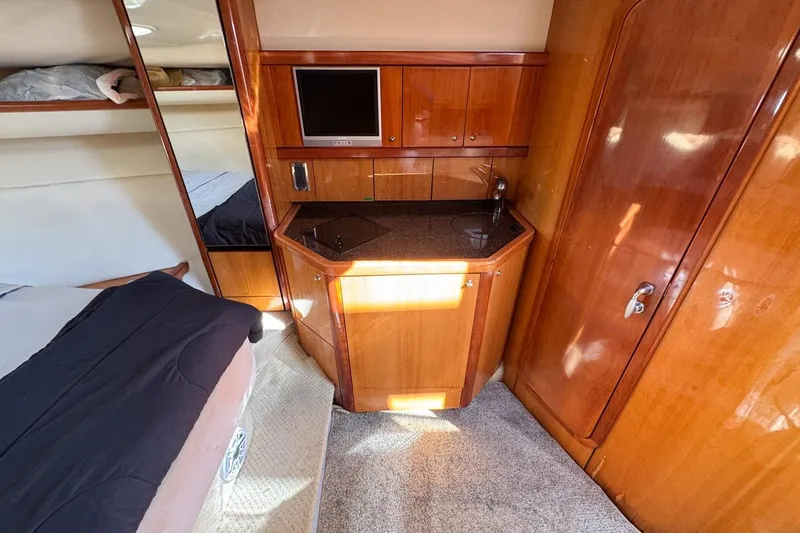 Slide: The Image of Interior of 2004 Sunseeker Sportfisher 37 with wood cabinetry and compact kitchenette. - 101