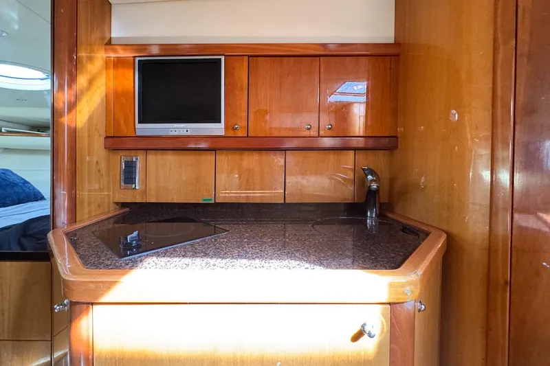Slide: The Image of 2004 Sunseeker Sportfisher 37 yacht interior with kitchenette and TV. - 102