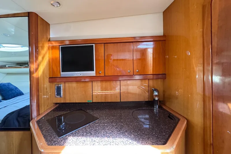 Slide: The Image of 2004 Sunseeker Sportfisher 37 yacht interior with kitchenette and TV. - 103