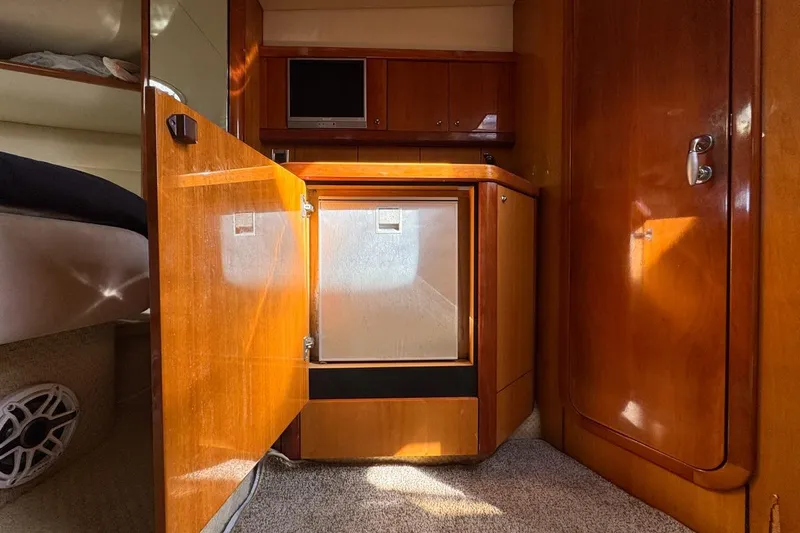Slide: The Image of Interior of 2004 Sunseeker Sportfisher 37 yacht with wooden cabinetry and compact fridge. - 107