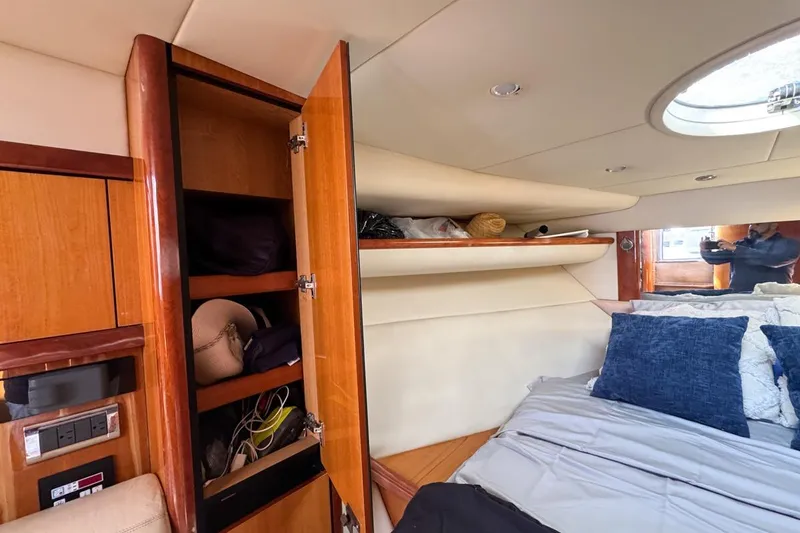 Slide: The Image of Interior cabin of 2004 Sunseeker Sportfisher 37 with open closet and bed. - 109