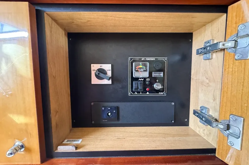 Slide: The Image of Electrical control panel inside a 2004 Sunseeker Sportfisher 37 yacht cabinet. - 111
