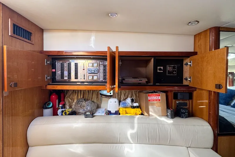 Slide: The Image of Interior of 2004 Sunseeker Sportfisher 37 with open cabinets and control panels. - 113