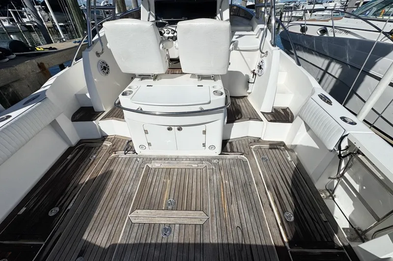 Slide: The Image of 2004 Sunseeker Sportfisher 37 boat interior with wooden deck and white seating. - 12