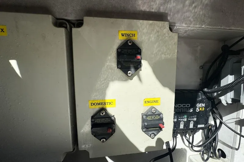 Slide: The Image of Electrical panel on a 2004 Sunseeker Sportfisher 37 boat with labeled switches. - 121