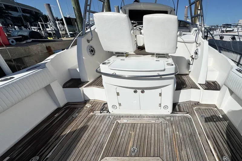 Slide: The Image of 2004 Sunseeker Sportfisher 37 boat interior with wooden deck and white seating. - 13