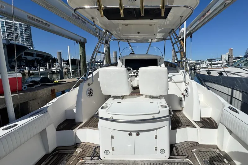 Slide: The Image of 2004 Sunseeker Sportfisher 37 boat interior at marina, featuring helm and seating. - 14