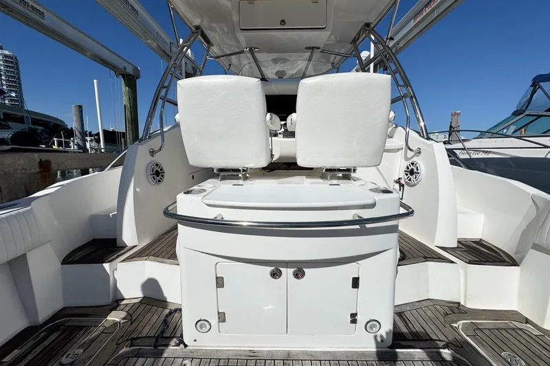 Slide: The Image of 2004 Sunseeker Sportfisher 37 boat interior with white seating and wooden deck. - 15