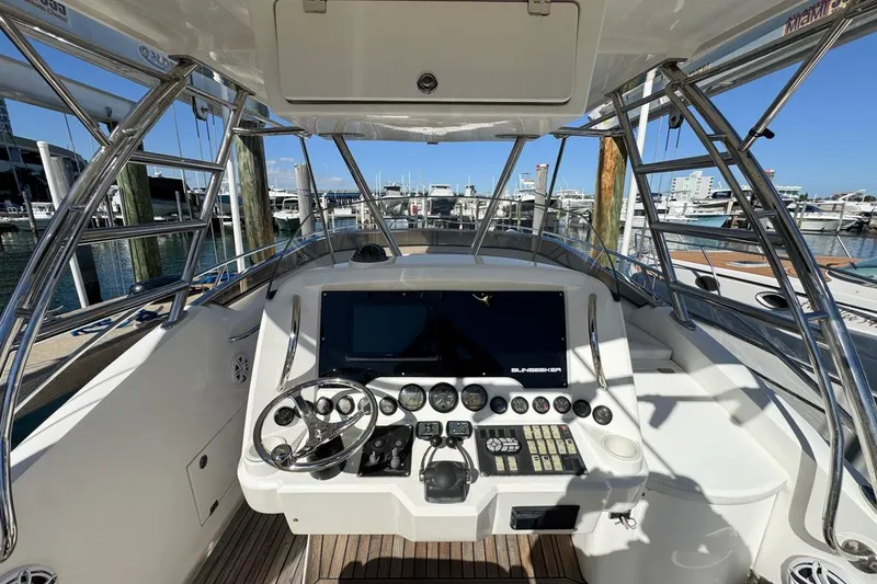 Slide: The Image of 2004 Sunseeker Sportfisher 37 helm with modern controls, docked at marina. - 21