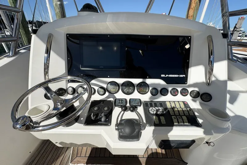 Slide: The Image of 2004 Sunseeker Sportfisher 37 helm with steering wheel, gauges, and controls. - 22