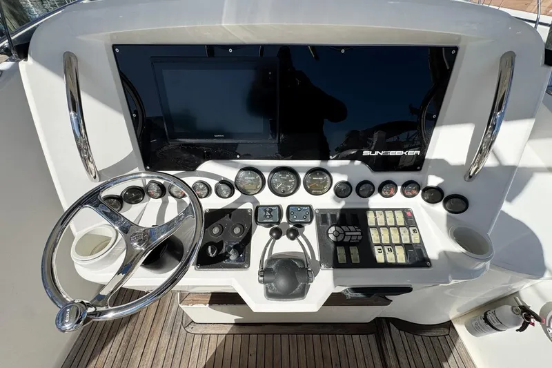 Slide: The Image of Control panel of a 2004 Sunseeker Sportfisher 37 boat with steering wheel and gauges. - 23
