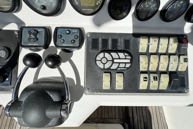 Slide: The Image of Control panel of a 2004 Sunseeker Sportfisher 37 boat with various switches and gauges. - 27