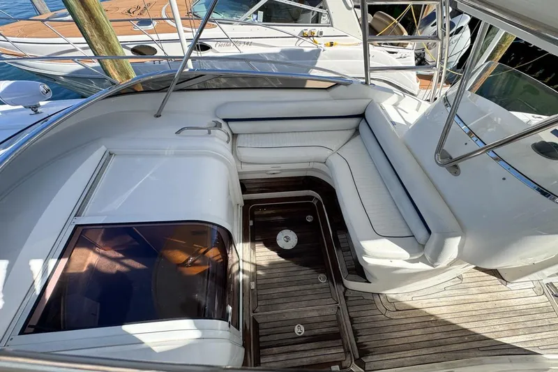 Slide: The Image of 2004 Sunseeker Sportfisher 37 boat interior with white seating and wooden deck. - 35