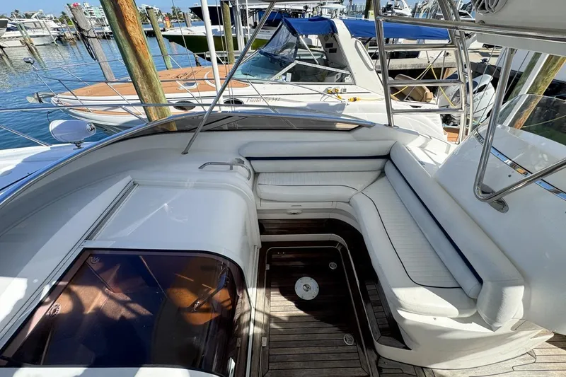 Slide: The Image of 2004 Sunseeker Sportfisher 37 boat interior with white seating and wooden deck. - 36