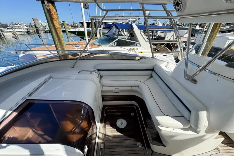 Slide: The Image of 2004 Sunseeker Sportfisher 37 boat interior with white seating and wooden deck. - 37