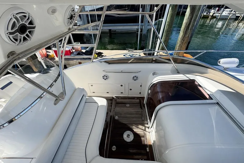 Slide: The Image of 2004 Sunseeker Sportfisher 37 boat interior with seating and speakers, docked at marina. - 38