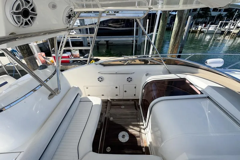 Slide: The Image of 2004 Sunseeker Sportfisher 37 boat interior with seating and wooden flooring at a marina. - 39