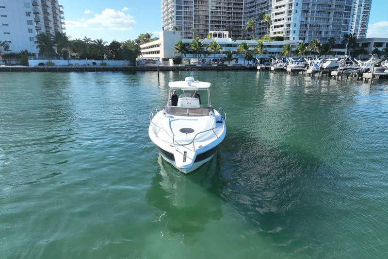 Slide: The Image of 2004 Sunseeker Sportfisher 37 yacht docked in a marina with cityscape backdrop. - 7
