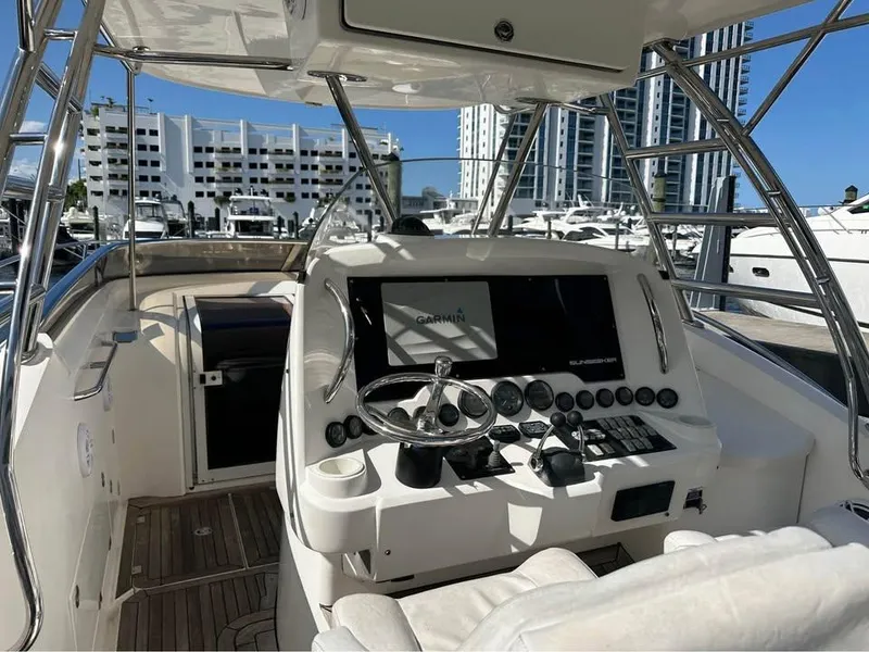 Slide: The Image of 2004 Sunseeker Sportfisher 37 yacht cruising in a marina under clear blue skies. - 4