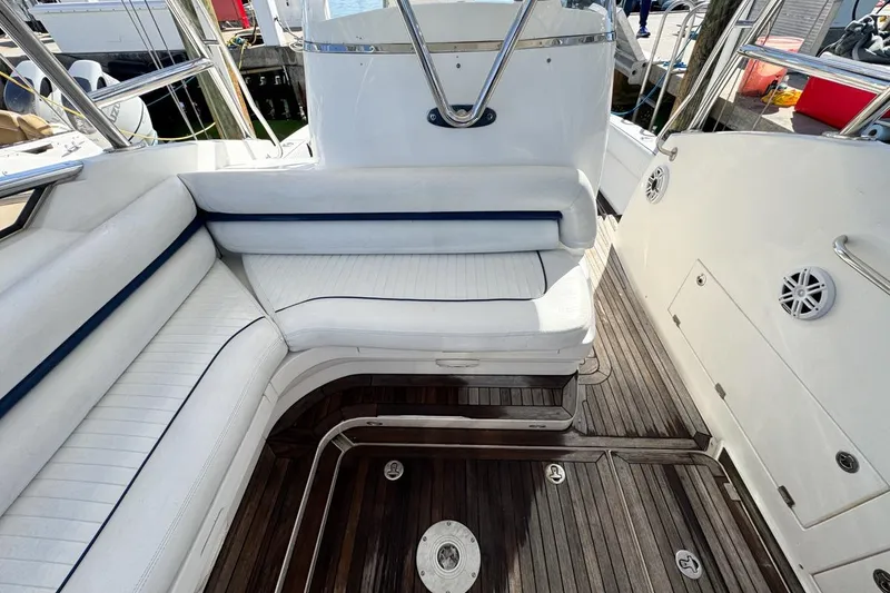 Slide: The Image of 2004 Sunseeker Sportfisher 37 interior with white seating and wooden deck. - 43