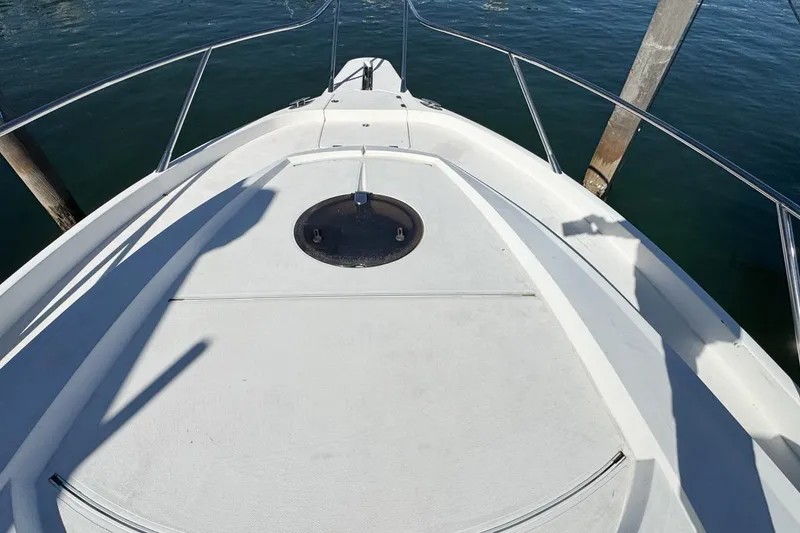 Slide: The Image of Bow of 2004 Sunseeker Sportfisher 37, featuring sleek design and stainless steel railings. - 47