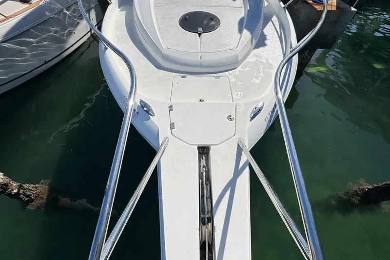 Slide: The Image of 2004 Sunseeker Sportfisher 37 boat bow with stainless steel railings in marina. - 53