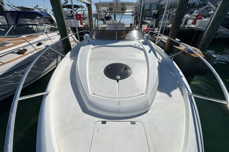 Slide: The Image of 2004 Sunseeker Sportfisher 37 docked at marina, showcasing sleek design and spacious deck. - 56