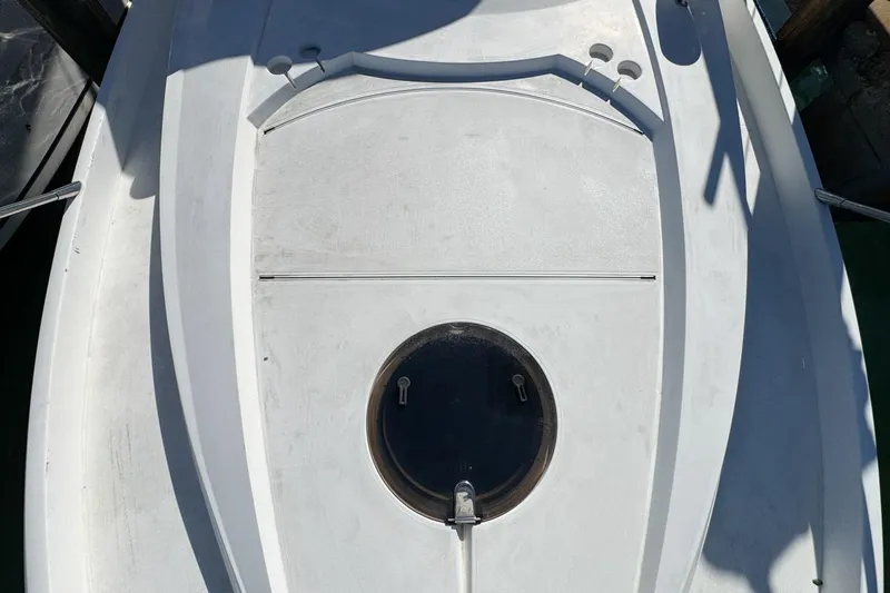 Slide: The Image of 2004 Sunseeker Sportfisher 37 boat deck with circular hatch and clean design. - 57