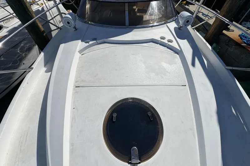 Slide: The Image of 2004 Sunseeker Sportfisher 37 boat deck with hatch, docked at marina. - 58