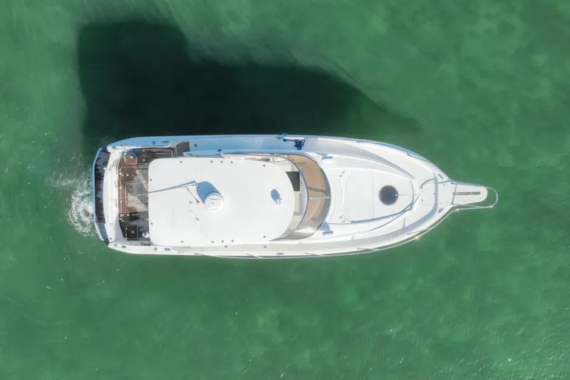 Slide: The Image of Aerial view of 2004 Sunseeker Sportfisher 37 yacht on clear green water. - 9