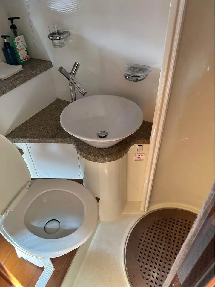 Slide: The Image of 2004 Sunseeker Sportfisher 37 boat on calm green water, aerial view. - 6