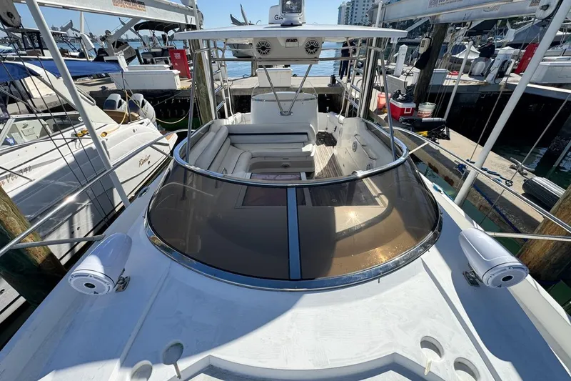 Slide: The Image of 2004 Sunseeker Sportfisher 37 yacht docked at marina, showcasing sleek design and spacious deck. - 62