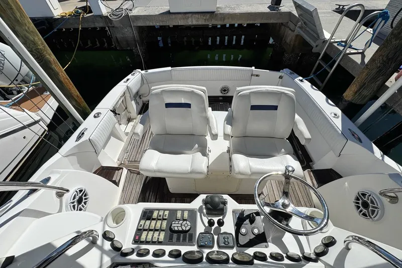 Slide: The Image of 2004 Sunseeker Sportfisher 37 cockpit with dual white seats and control panel. - 66