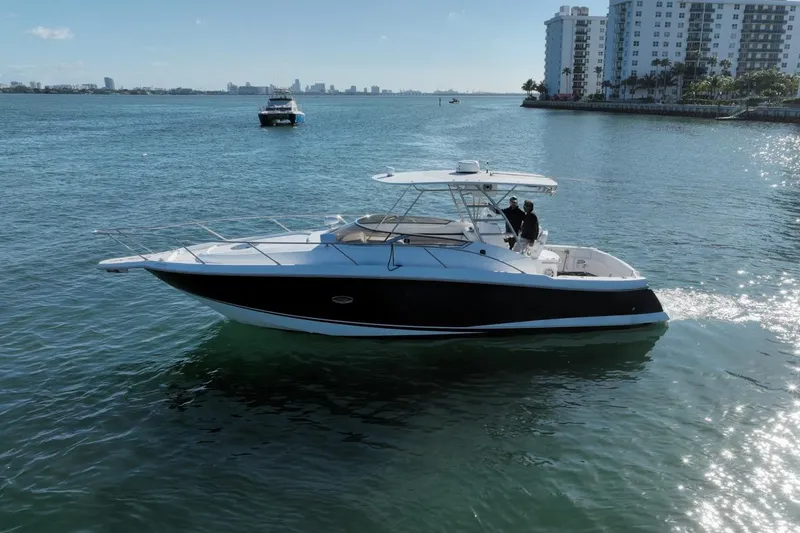 Slide: The Image of 2004 Sunseeker Sportfisher 37 cruising on a sunny day near coastal buildings. - 2