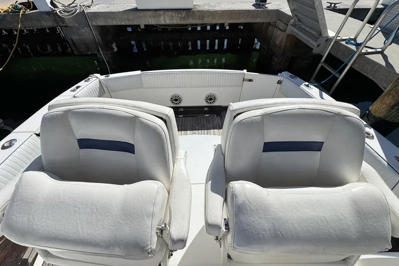 Slide: The Image of 2004 Sunseeker Sportfisher 37 boat interior with white seating at dock. - 70