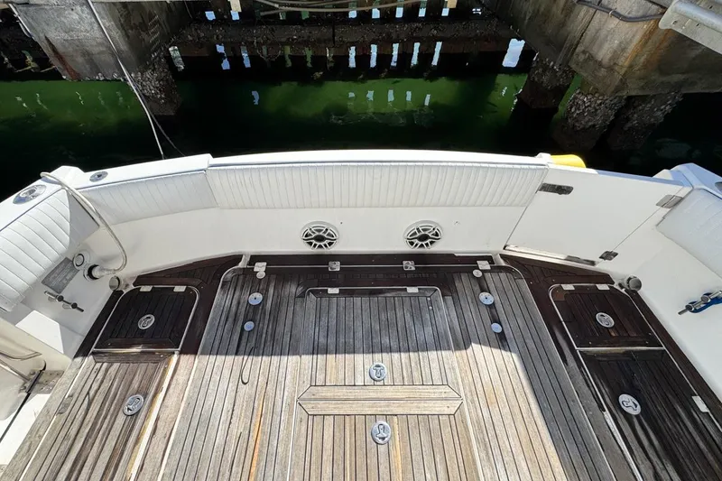 Slide: The Image of 2004 Sunseeker Sportfisher 37 boat deck with wood finish and white seating. - 71
