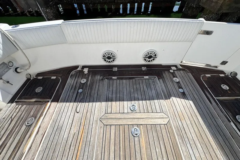 Slide: The Image of Sunseeker Sportfisher 37, 2004 model, featuring a wooden deck and white seating. - 73