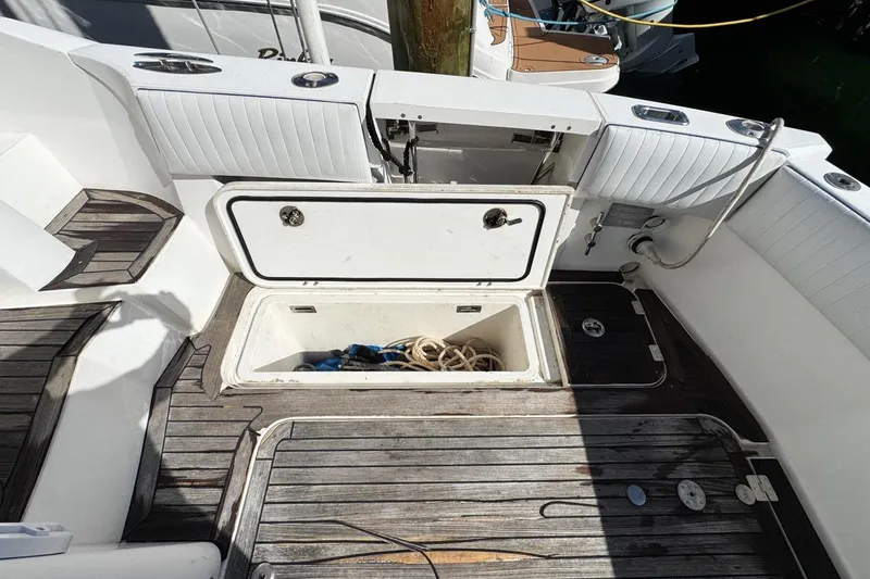 Slide: The Image of 2004 Sunseeker Sportfisher 37 deck with storage compartments and wooden flooring. - 76