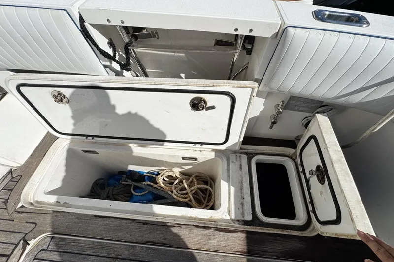 Slide: The Image of Storage compartments on a 2004 Sunseeker Sportfisher 37 boat, containing ropes and equipment. - 77