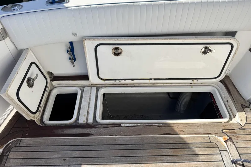 Slide: The Image of Open storage compartments on a 2004 Sunseeker Sportfisher 37 boat deck. - 78