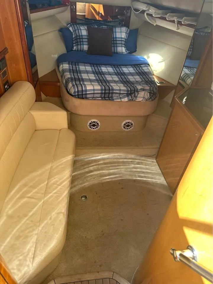 Slide: The Image of 2004 Sunseeker Sportfisher 37 yacht on calm waters with city skyline in background. - 8