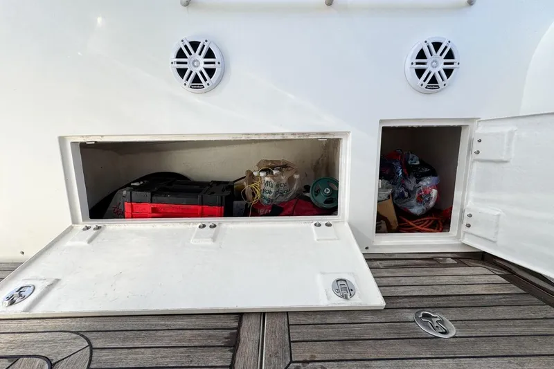 Slide: The Image of Storage compartments on a 2004 Sunseeker Sportfisher 37 boat deck, containing various equipment. - 82