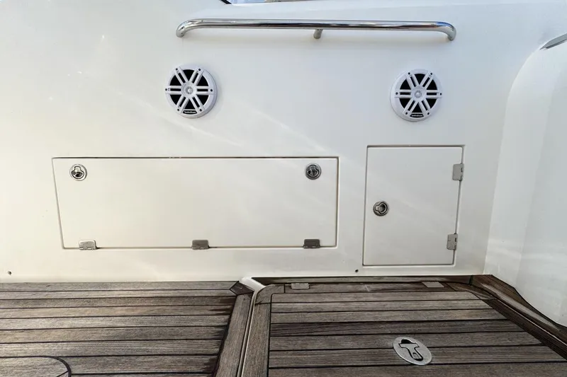 Slide: The Image of 2004 Sunseeker Sportfisher 37 boat deck with storage compartments and speakers. - 83